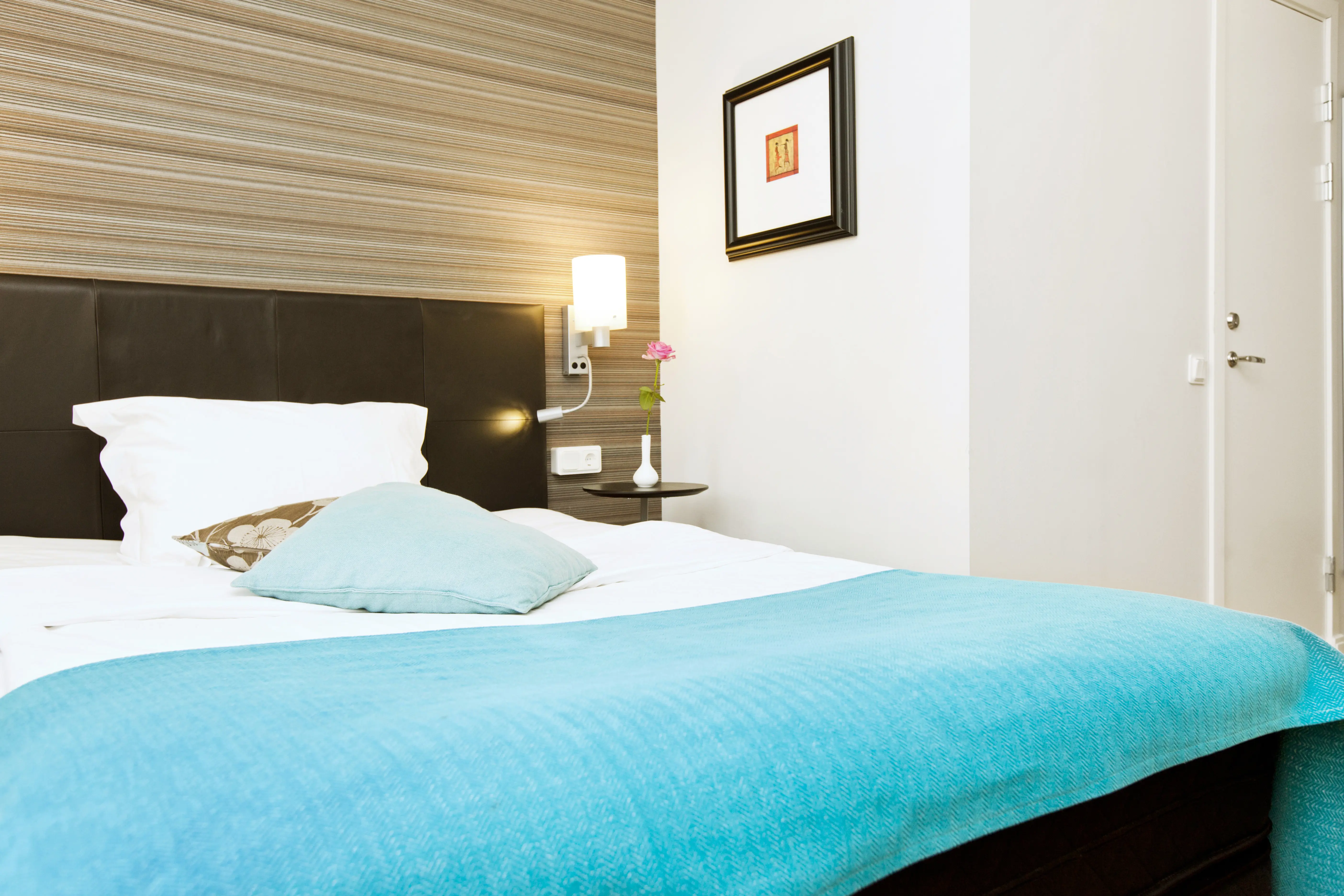 Hotel room with double bed, blackboard and bedside lamp