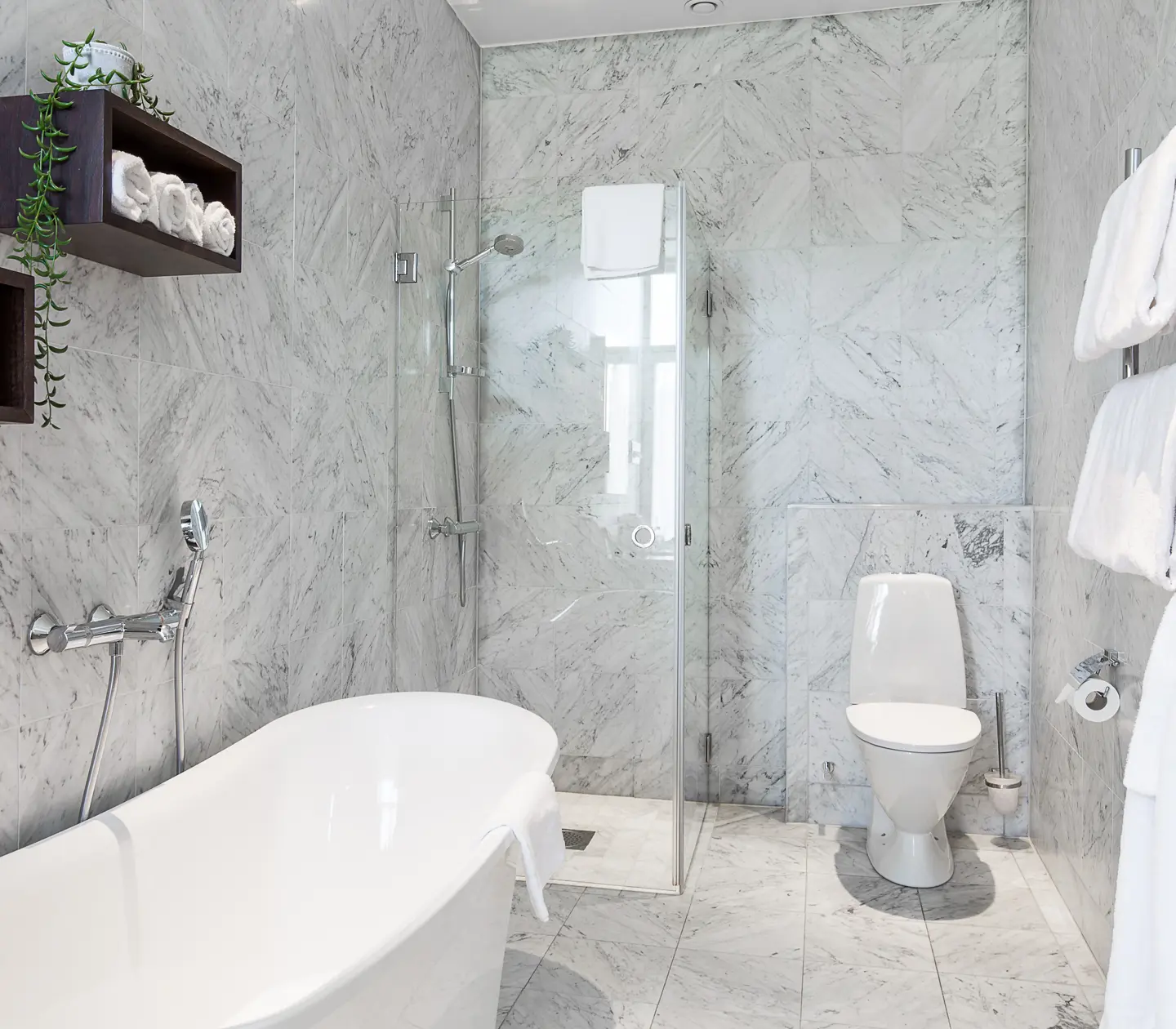 Bright bathroom with toilet, shower and bathtub