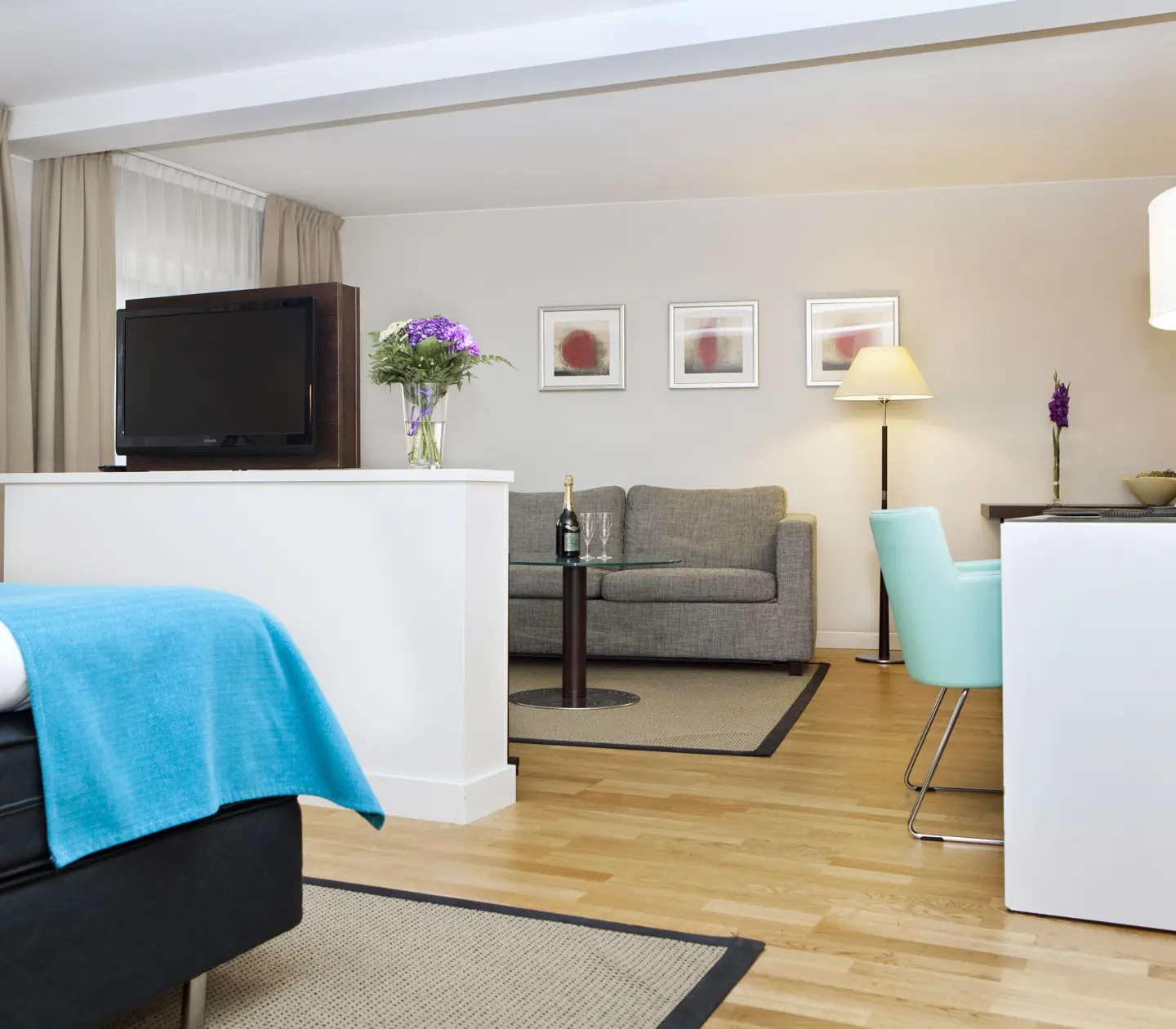 Bright suite with bed, desk and sofa