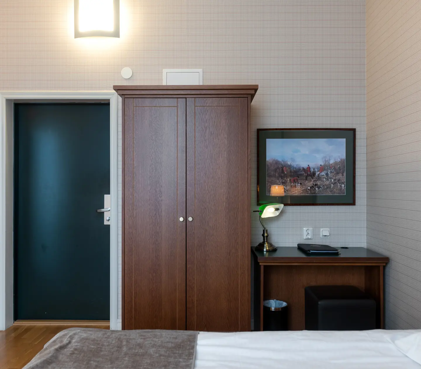 Hotel room with TV, desk and wardrobe