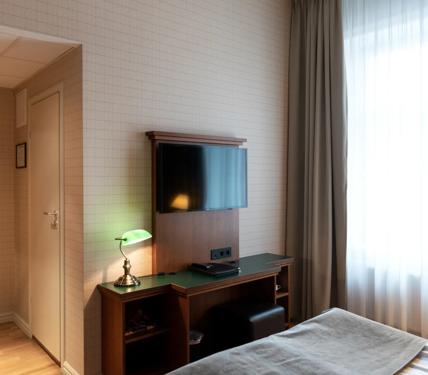 Hotel room with mirror, desk and TV