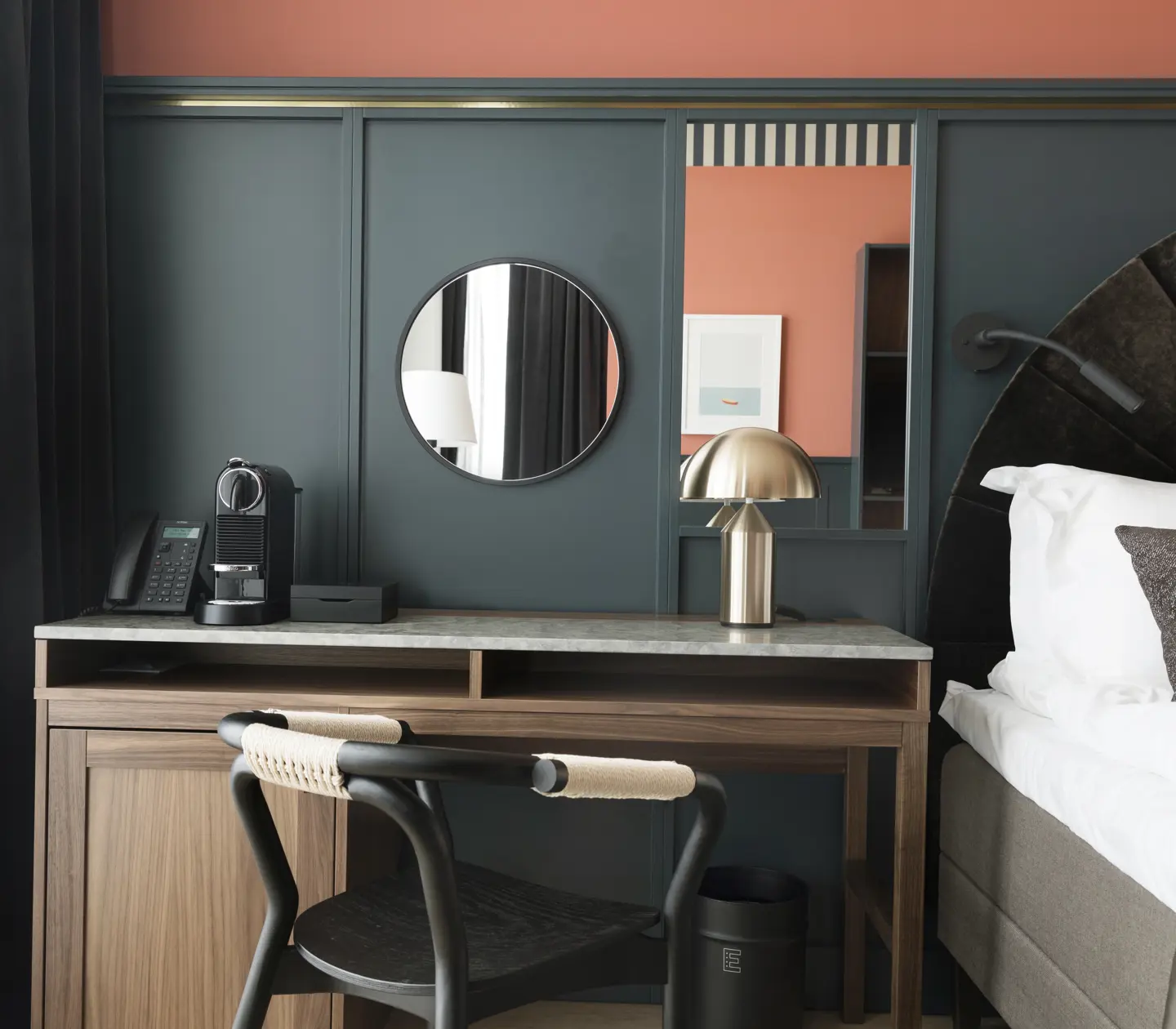 Cozy hotel room with bed, desk, blue and red wall